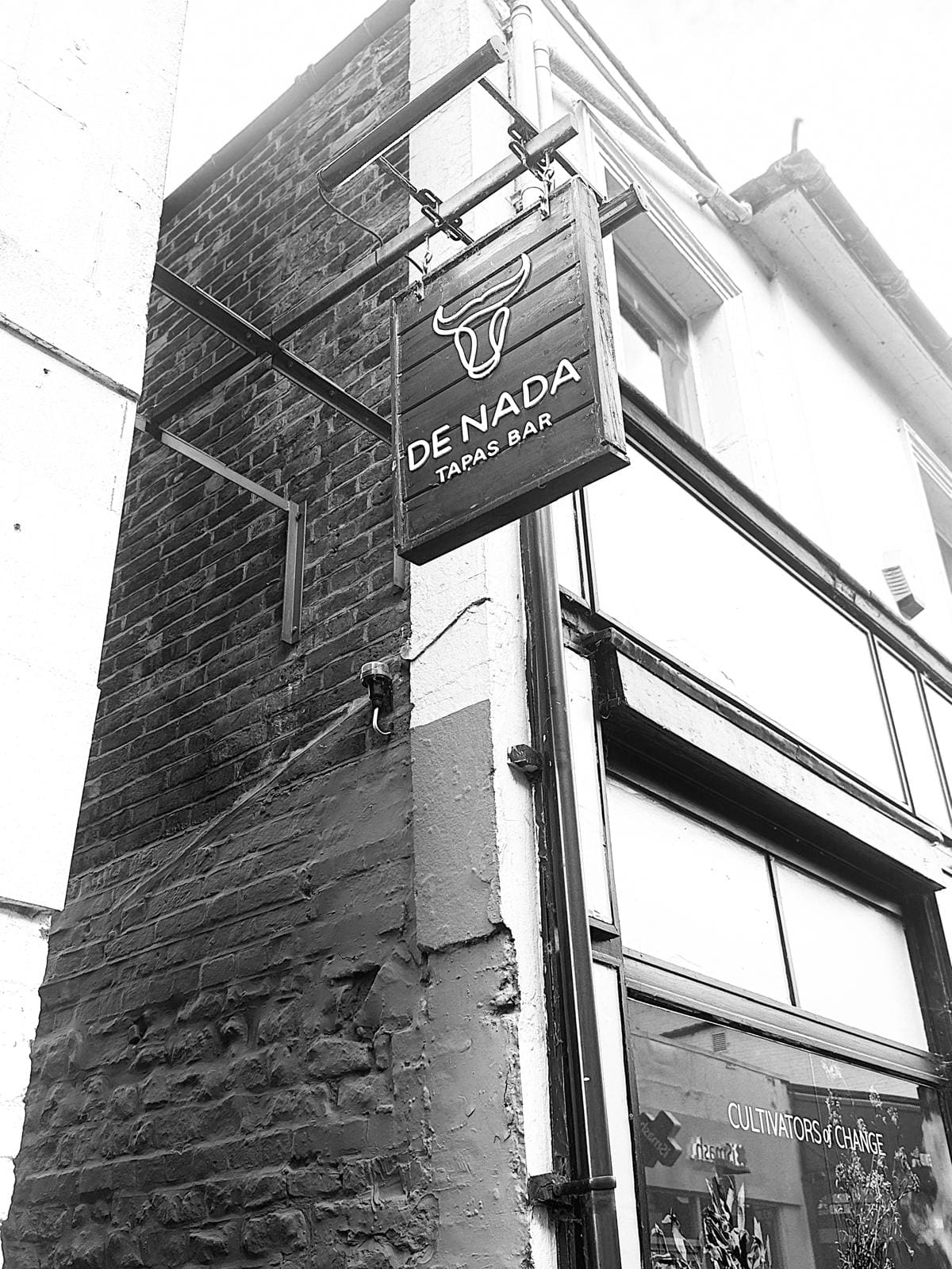 The De Nada hanging sign on Market Street